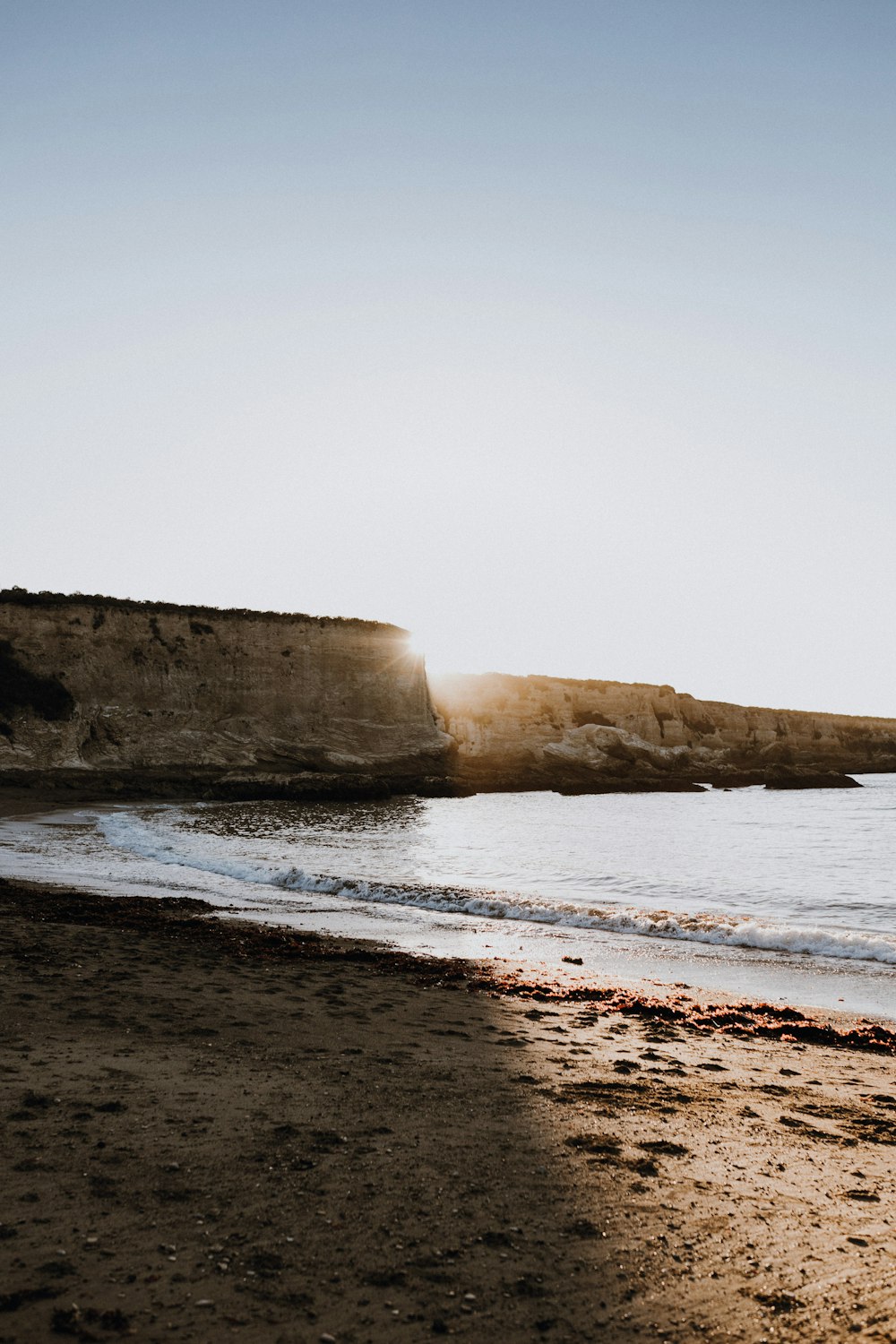 a person walking on a beach next to the ocean