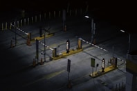 a parking lot at night with a lot of parking meters