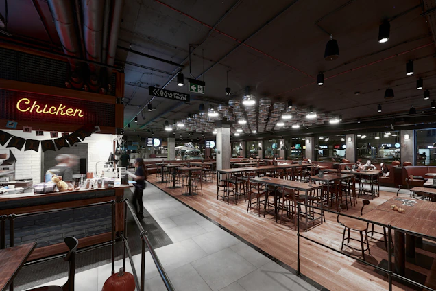 Modern fried chicken restaurant interior with professional kitchen and busy dining area under soft lighting.