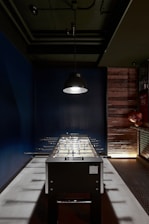 A technician installing a foosball table in a cozy game room.