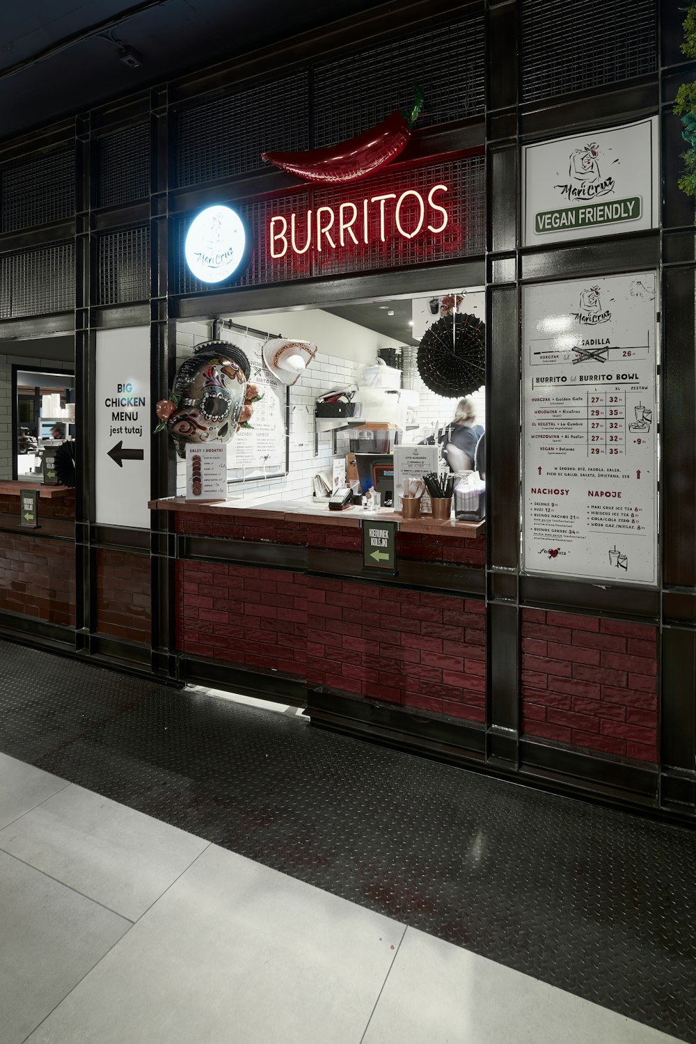 a restaurant called burritos is lit up at night