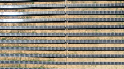 Solar panels glistening under the bright sun in a desert landscape