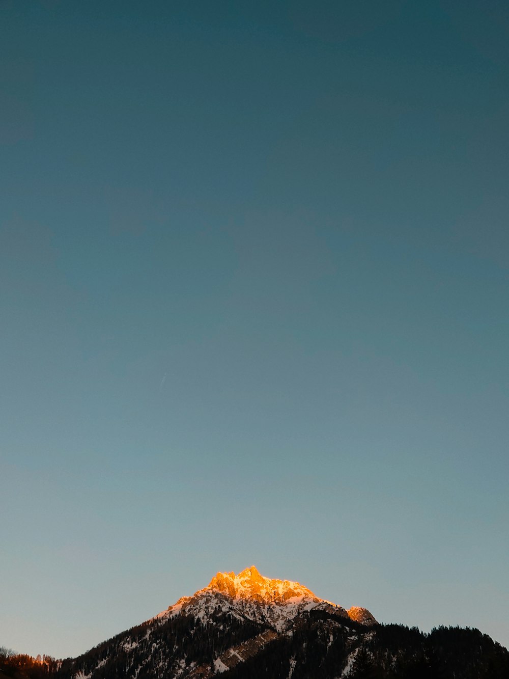 a mountain with a snow capped peak in the distance