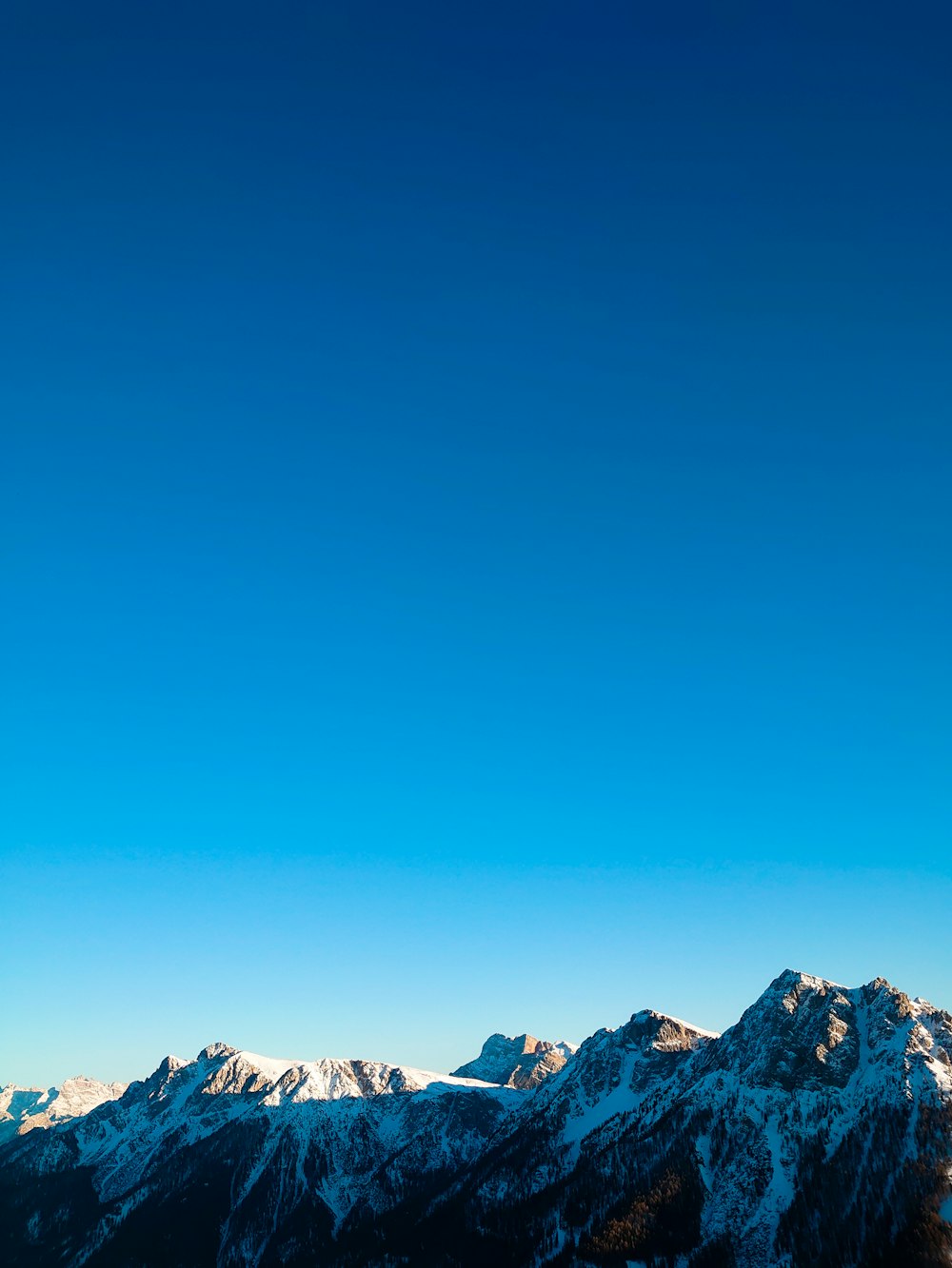 a person on a snowboard on top of a mountain