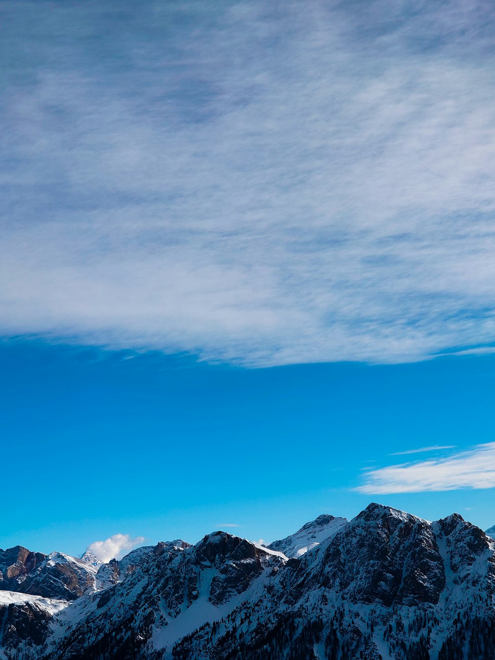 a group of people riding skis on top of a snow covered slope