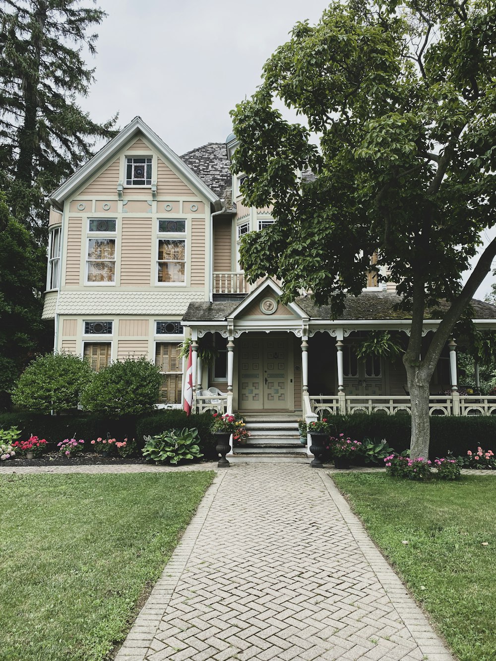 a brick walkway leading to a large house