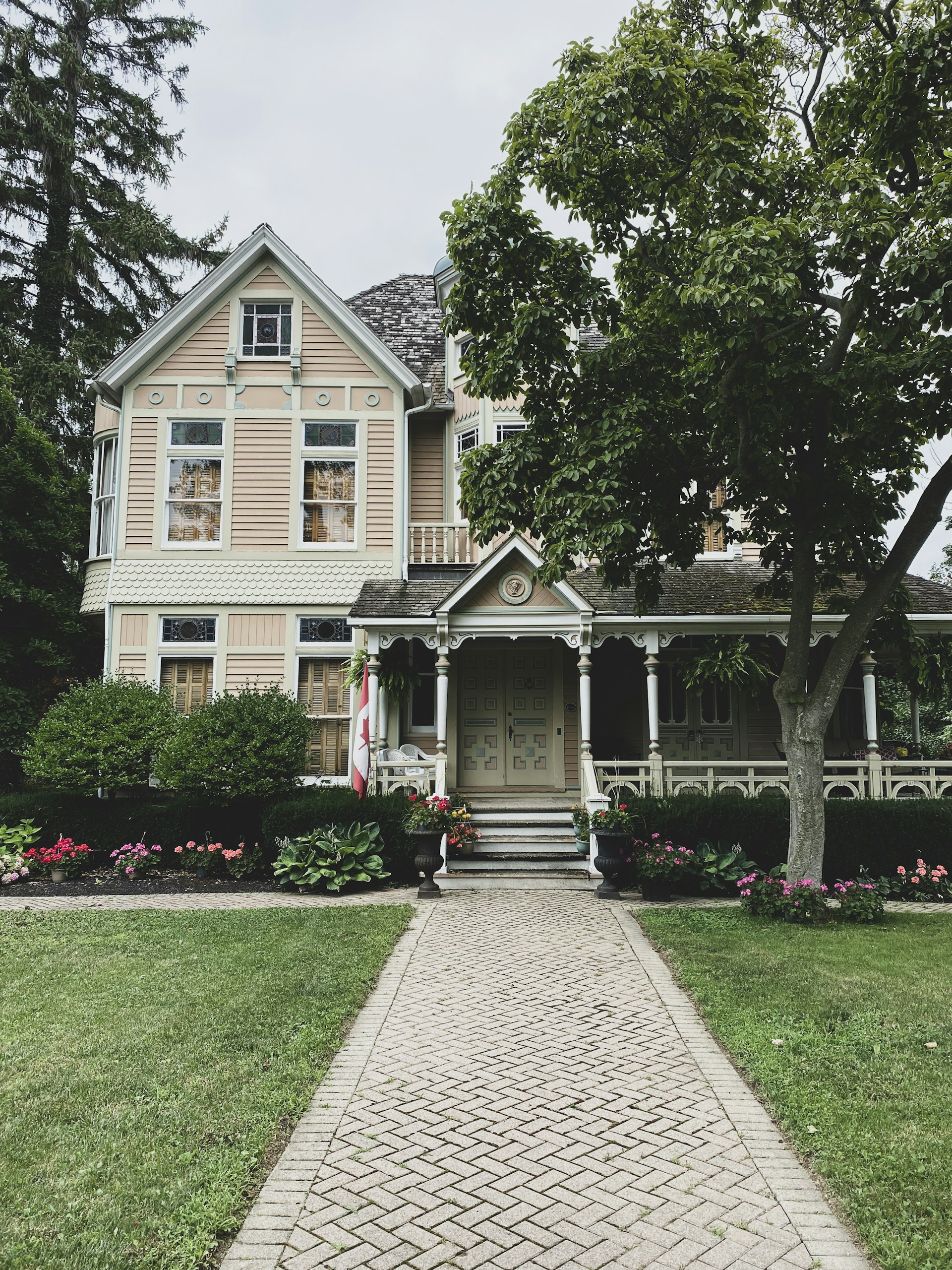 a brick walkway leading to a large house