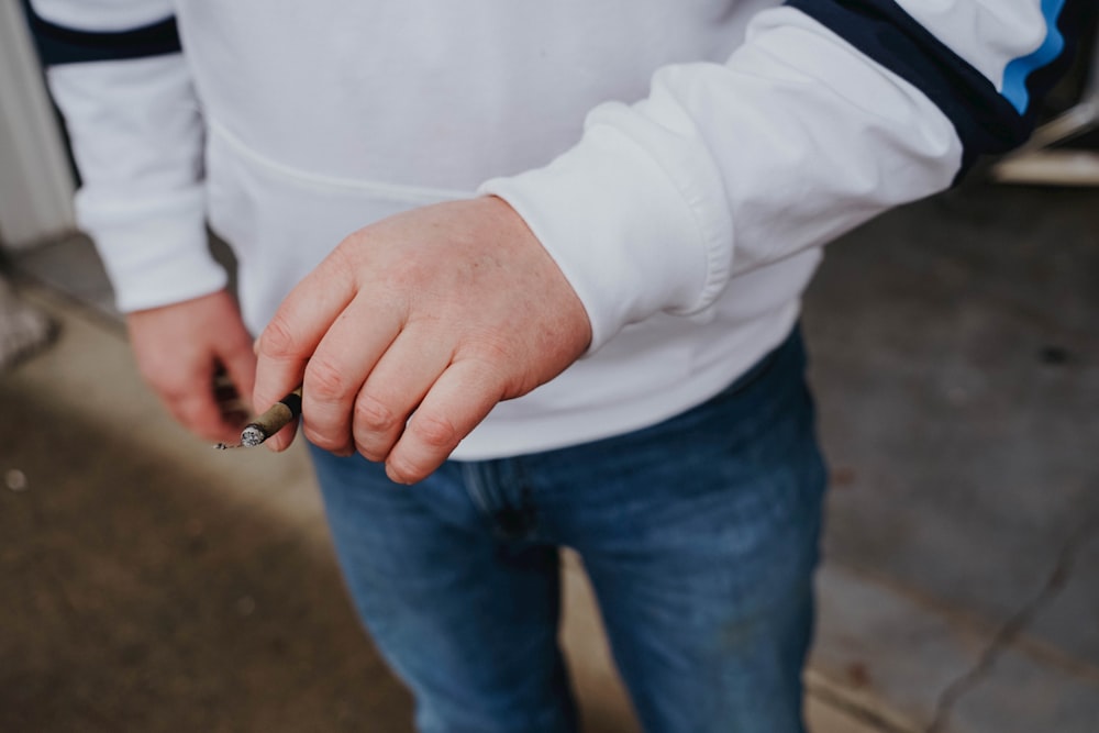a man holding a cigarette in his hand