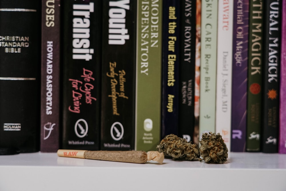 a cigarette sitting on top of a white shelf