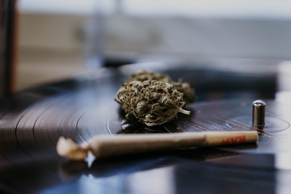 a cigarette sitting on top of a record