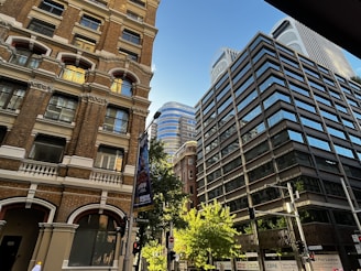 a couple of tall buildings sitting next to each other