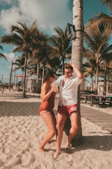 A couple enjoying a sunny vacation on a tropical beach.