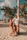 Happy couple enjoying a sunny beach resort with palm trees