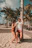Happy couple enjoying a sunny beach resort with palm trees