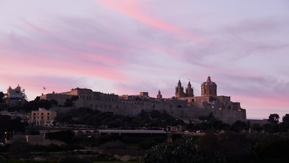 a city with a castle on top of a hill