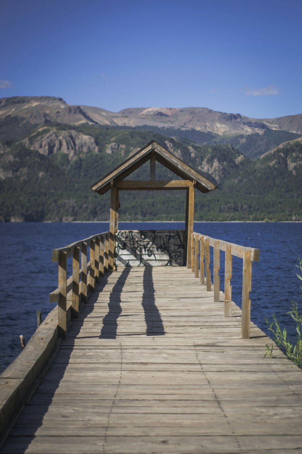 a wooden dock with a gazebo on the end of it