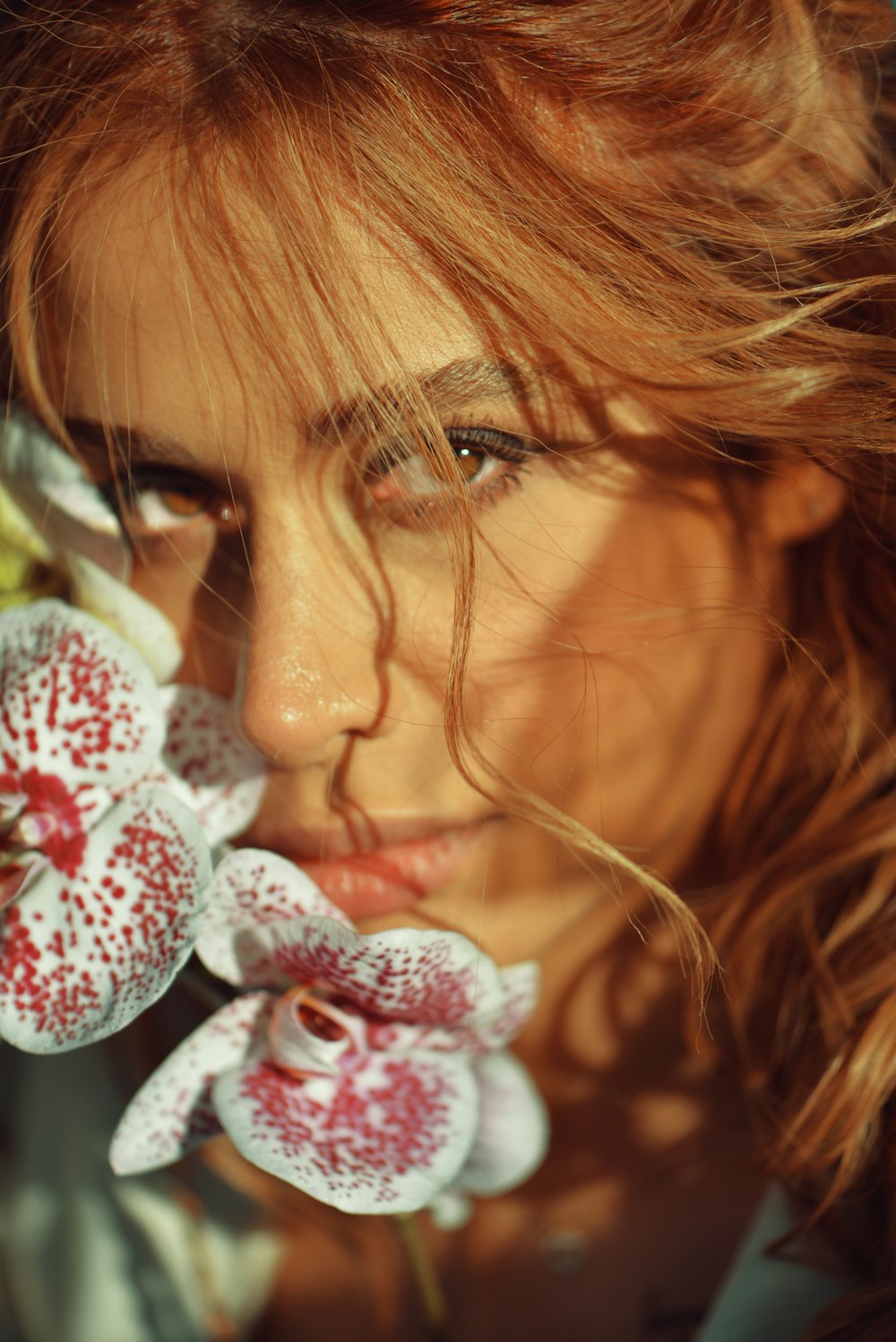 a close up of a woman with flowers in her hair
