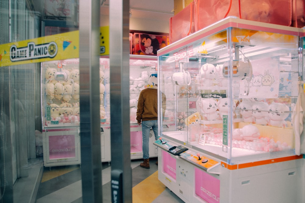 a man standing in front of a display case in a store