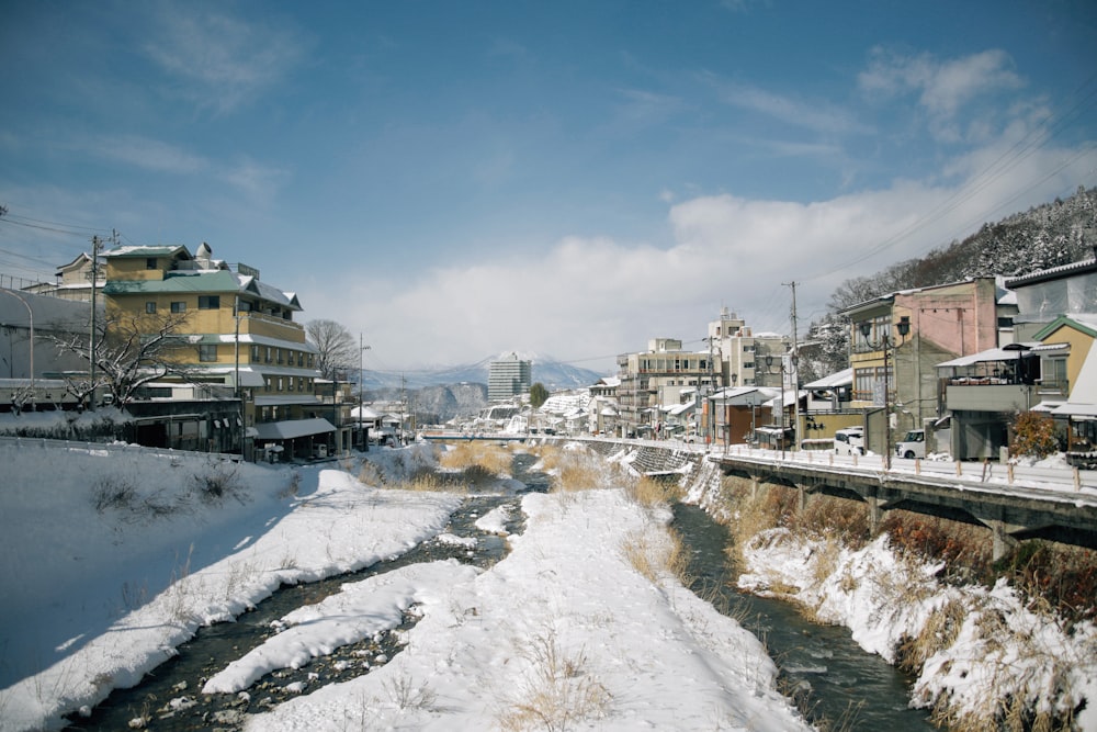 a river running through a snow covered town