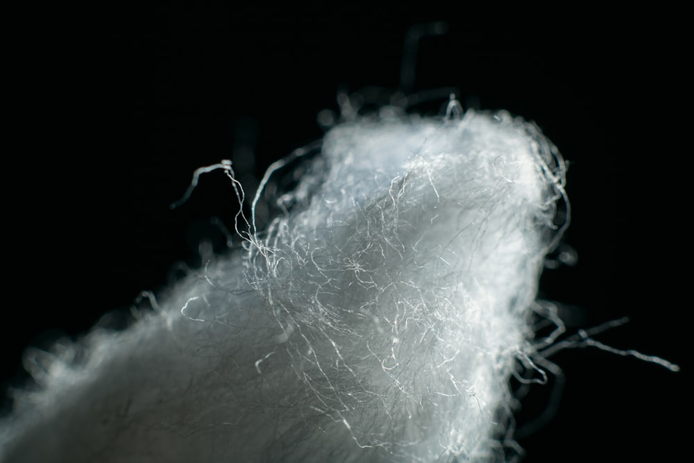 a close up of a white substance on a black background