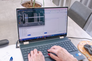 A person filling out a form on a laptop.