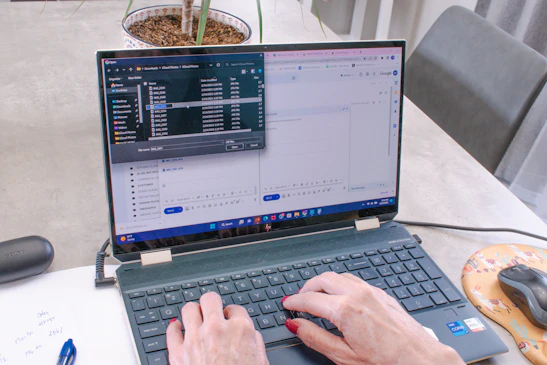 A person happily filling out an online appointment form on a laptop.