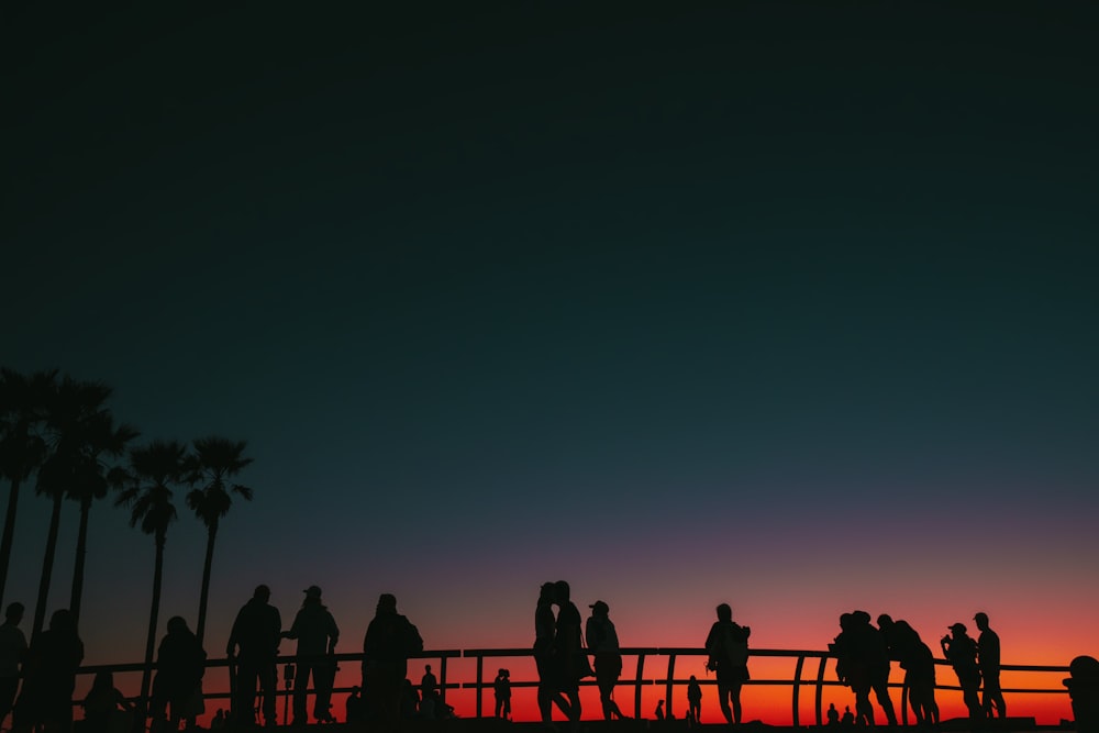 a group of people standing on top of a bridge