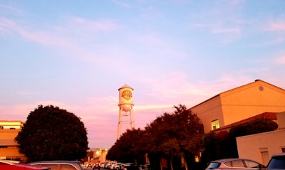a water tower in the middle of a parking lot