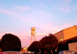 a water tower in the middle of a parking lot
