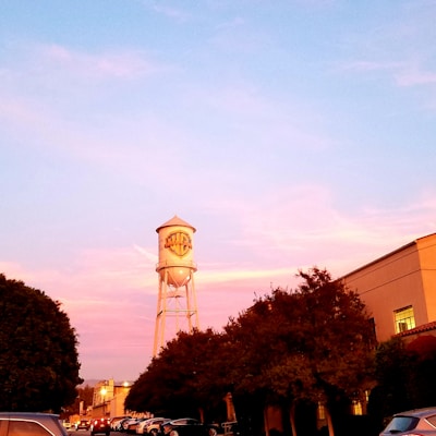 a water tower in the middle of a parking lot