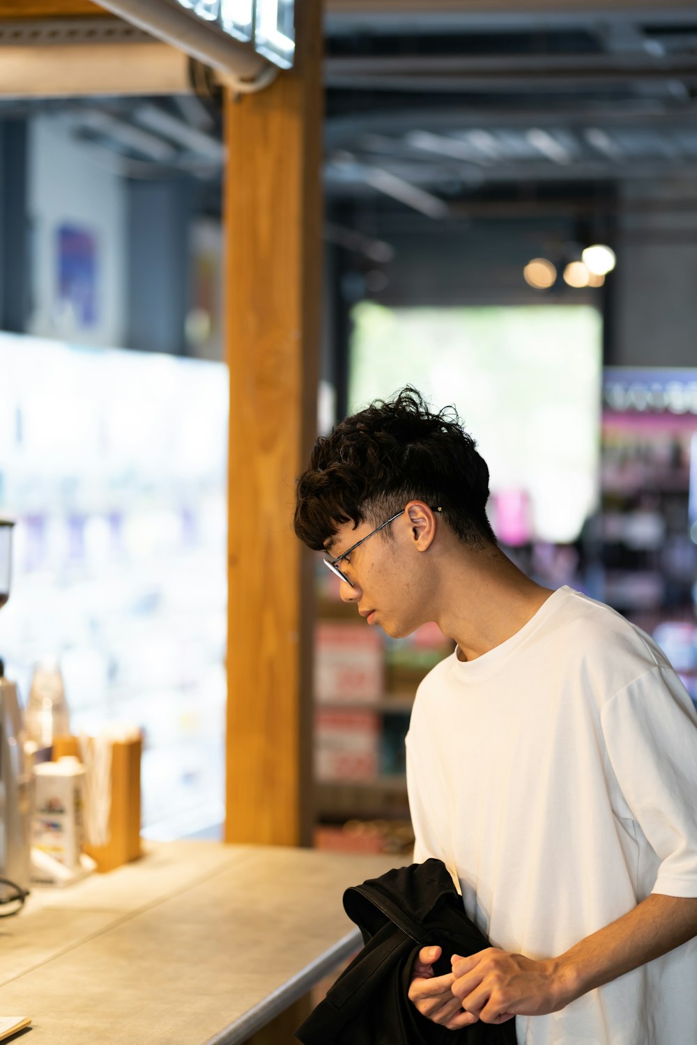 a man standing at a counter in a store