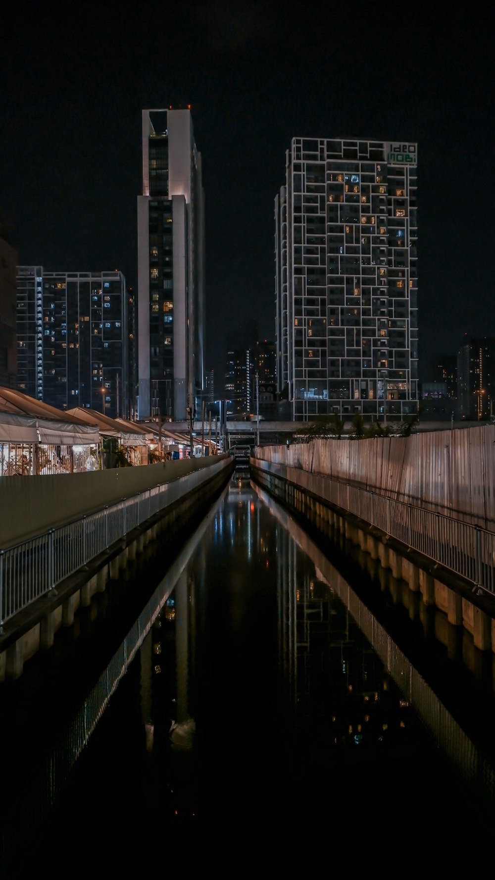 a city at night with a river running through it