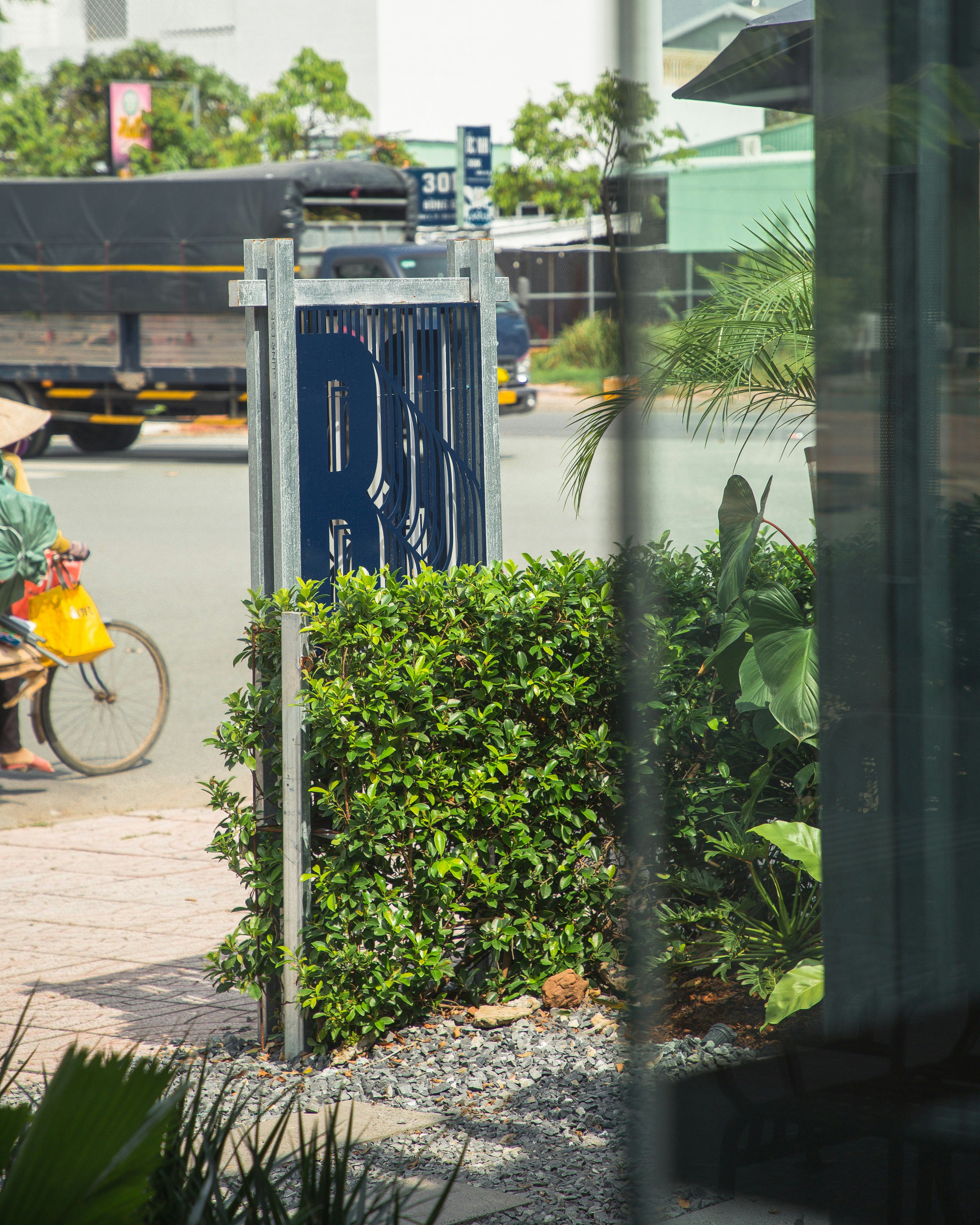 a man riding a bike down a street next to a tall building