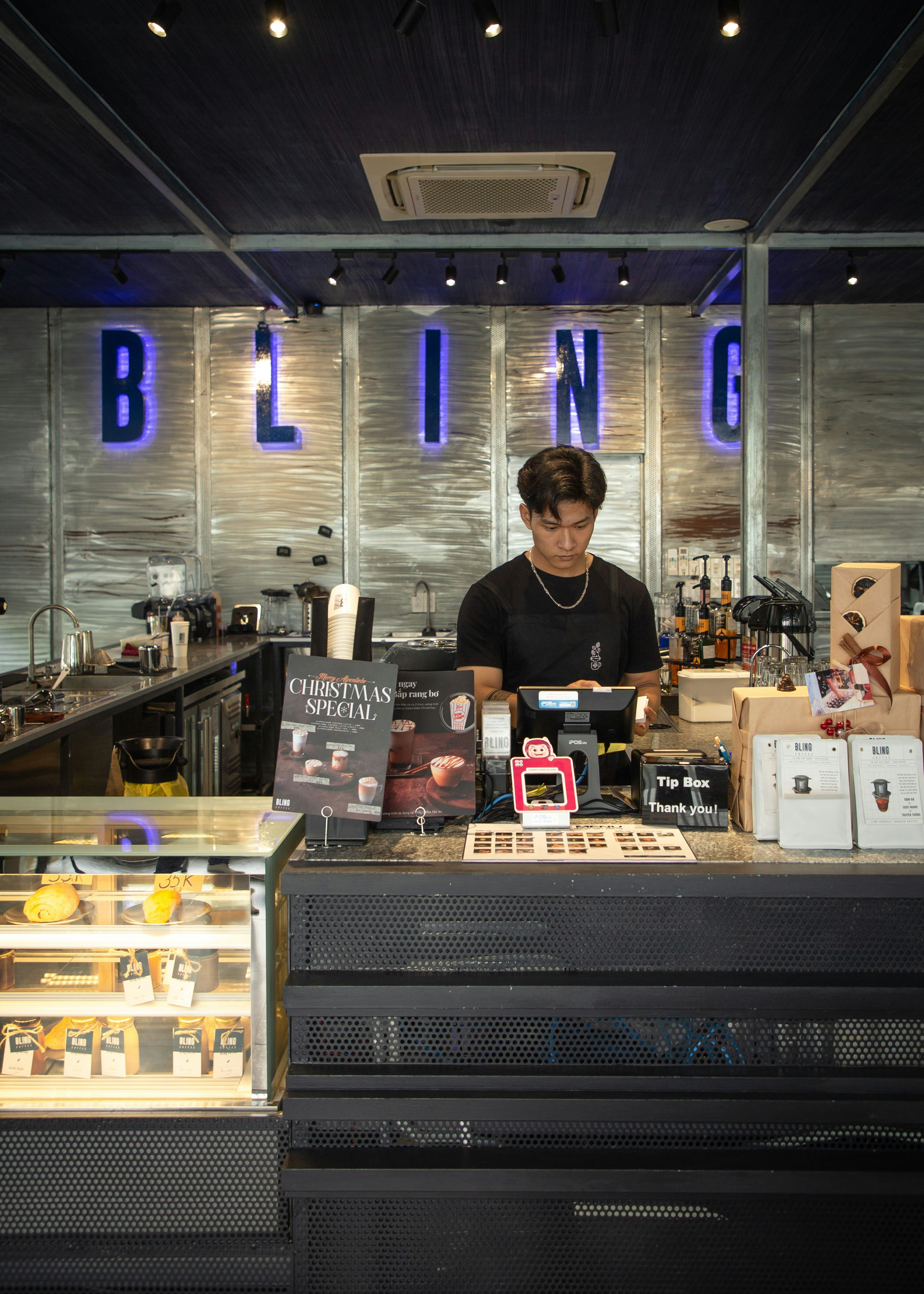 a man standing behind a counter in a store