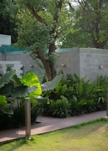 A serene modern garden with lush greenery and elegant landscaping under soft natural light.