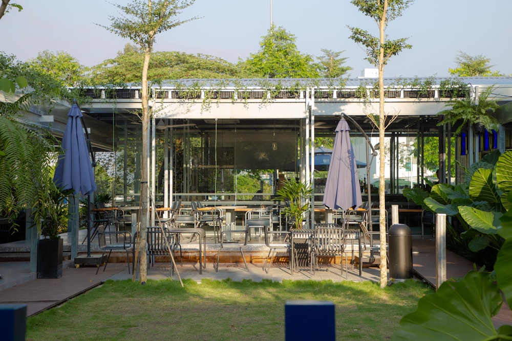 an outdoor dining area with tables and umbrellas