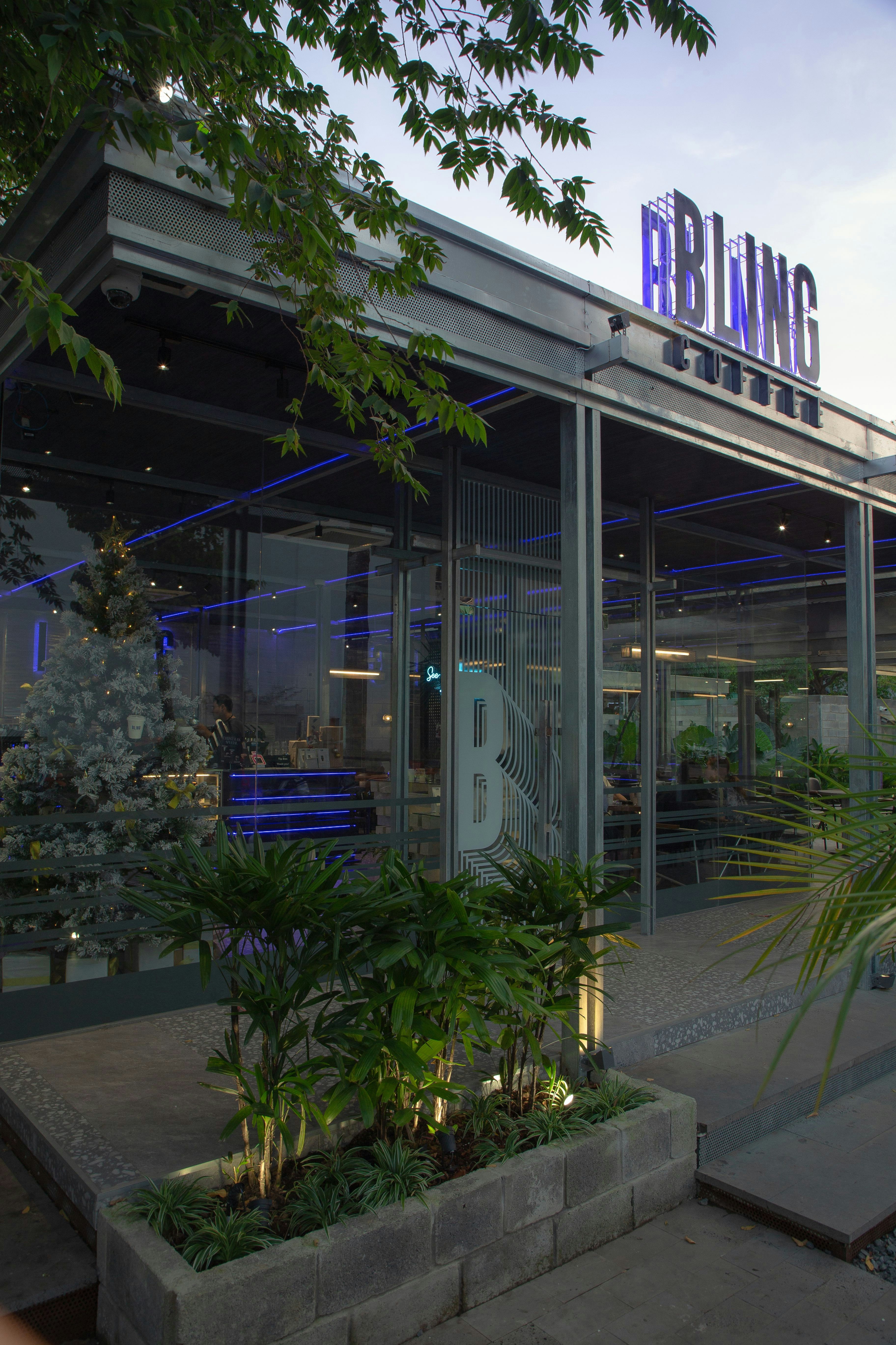 the front of a building with plants in front of it