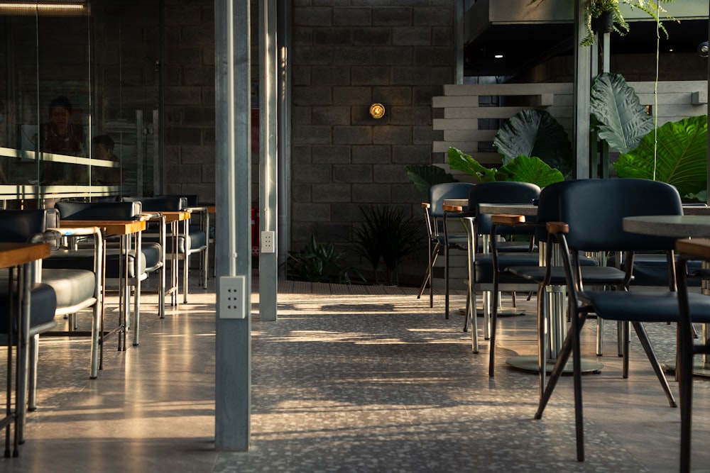 a restaurant with tables and chairs and a brick wall