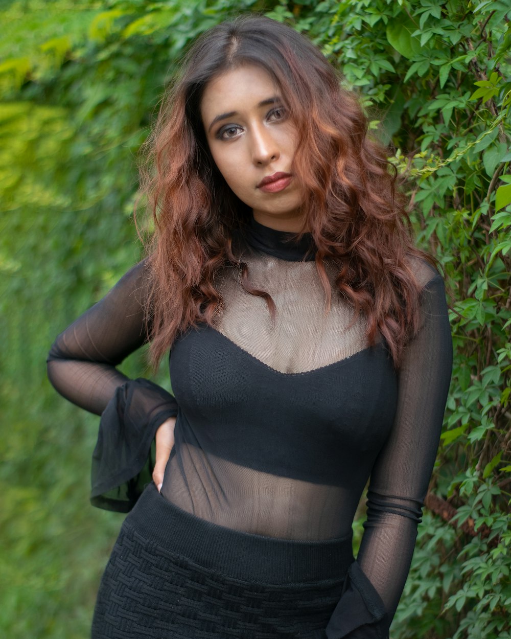 a woman in a black dress posing for a picture