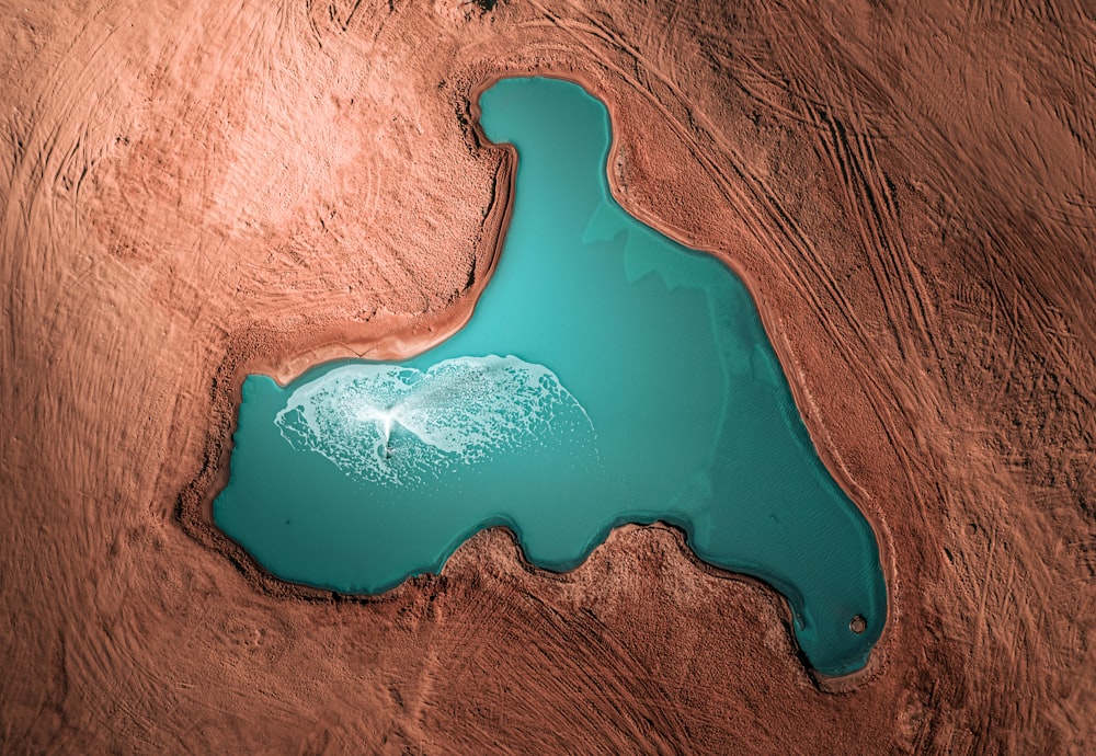 an aerial view of a lake in the desert