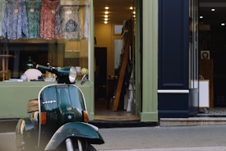 A happy customer wearing Vespa Club of Knoxville merchandise while riding a Vespa.