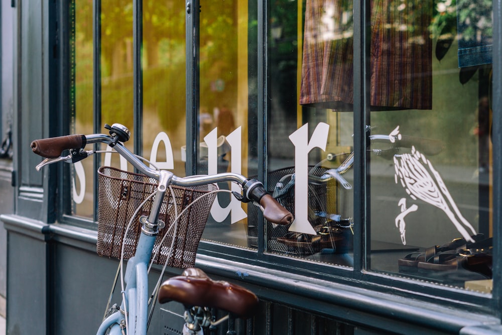 a bicycle parked in front of a store window