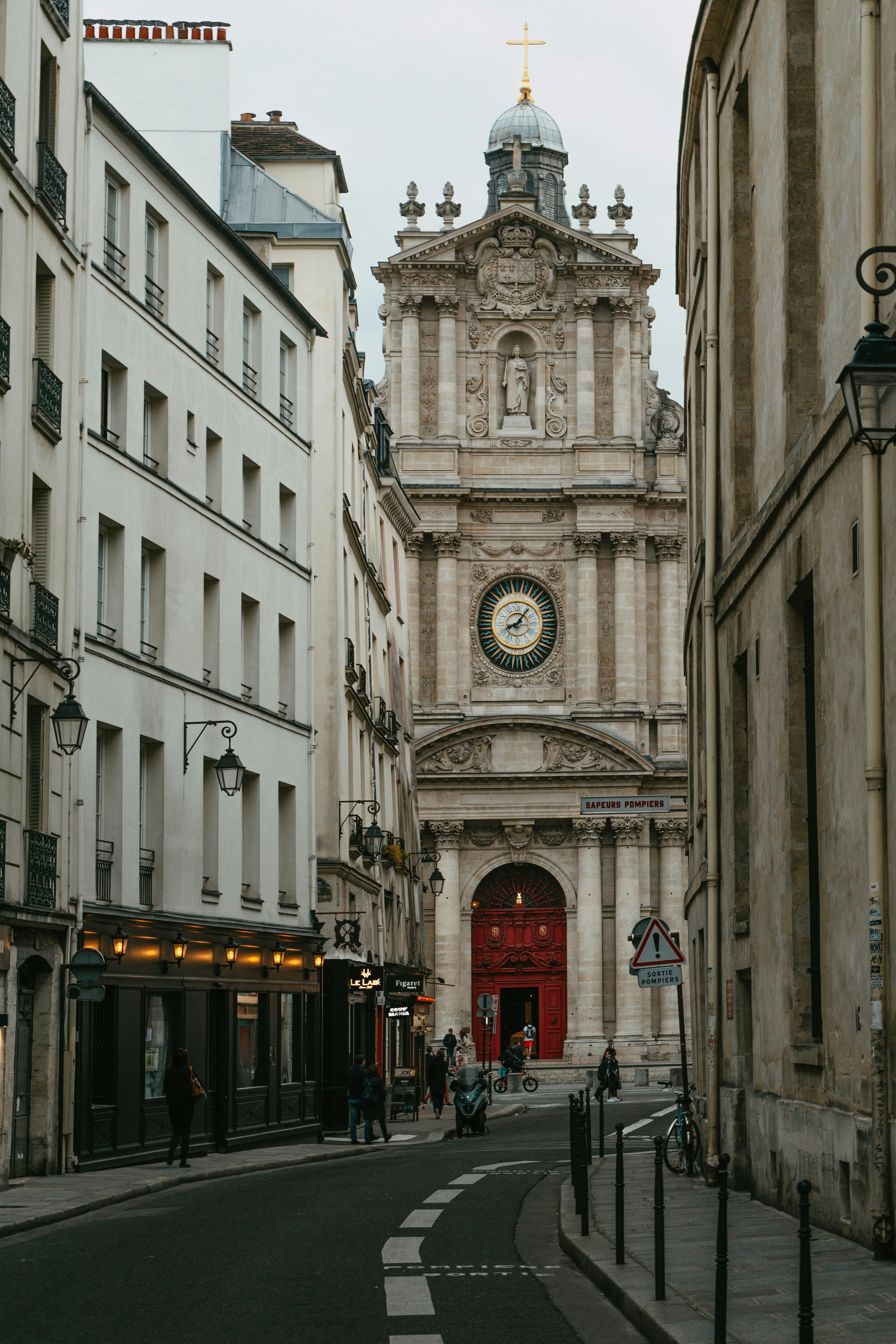 a city street with a clock tower in the background