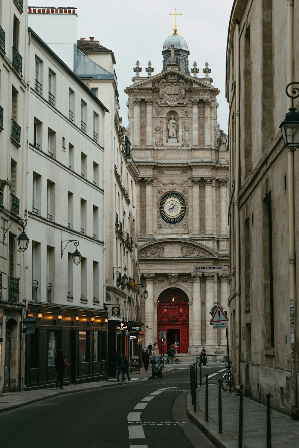 a city street with a clock tower in the background