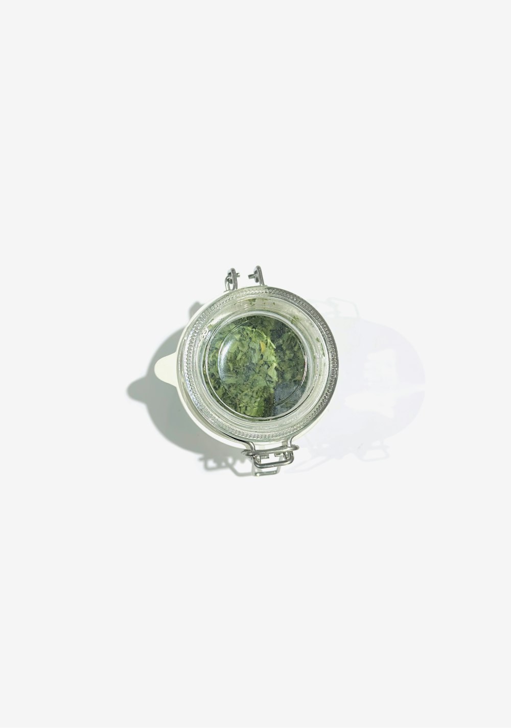 a small mirror with a green plant inside of it
