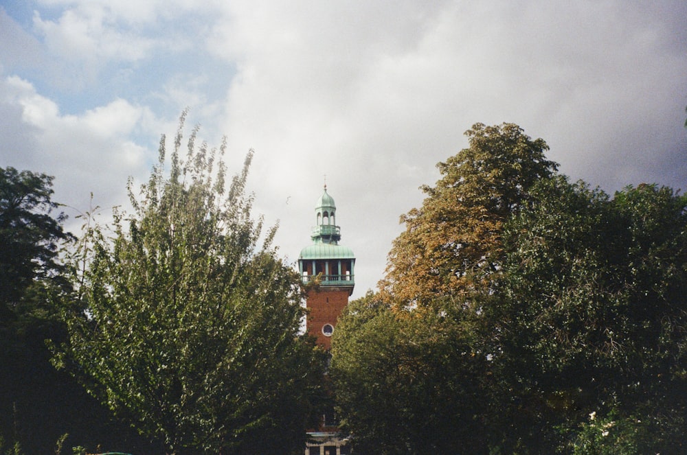 a clock tower in the middle of a park