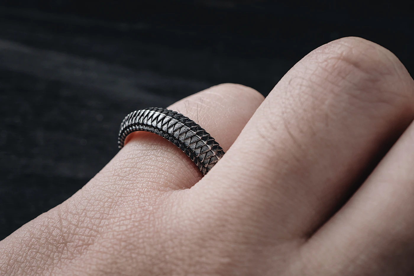 Hand wearing a single sculptural ring — atelier detail, portrait placeholder