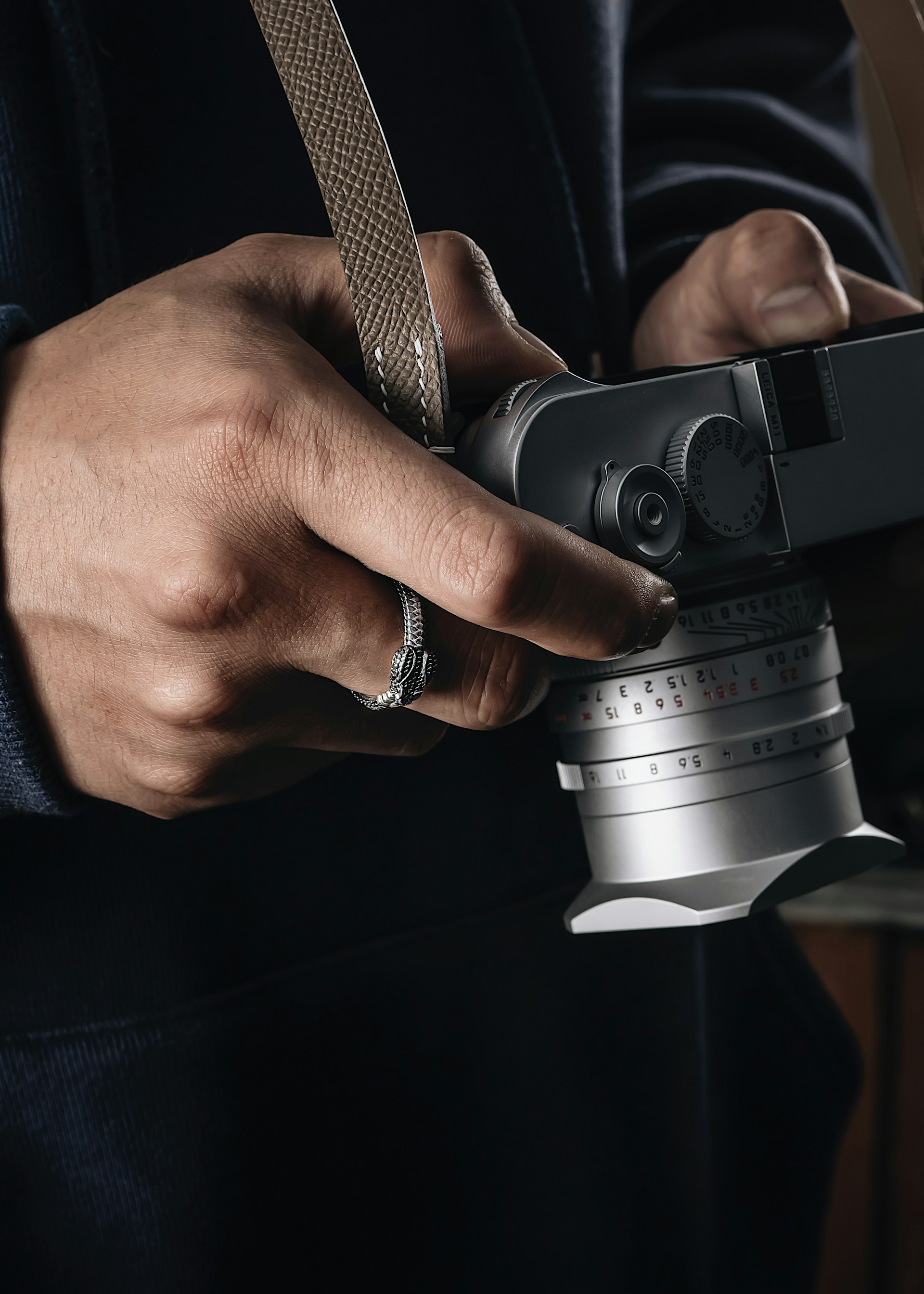 An intimate close-up of a weathered hand holding a vintage camera, capturing the essence of photography.
