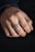 Close-up of a hand wearing a delicate silver ring with soft natural lighting.
