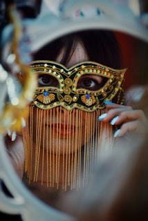 a woman wearing a mask looking through a mirror
